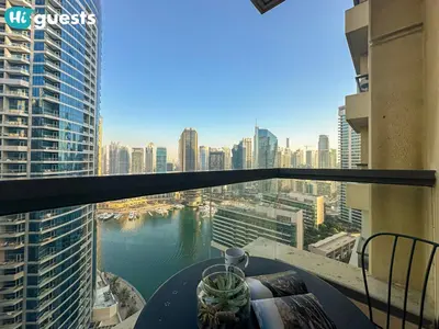 a balcony with a table and a view of a city at HiGuests - Artistic Waterfront Apt, Perfect for Beach Lovers in Dubai