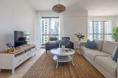 a living room with a couch and a table at Frank Porter - Murjan 6 in Dubai