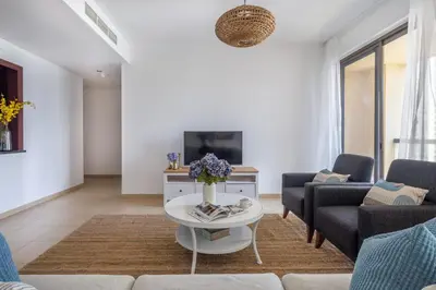 a living room with a couch and a table at Frank Porter - Murjan 6 in Dubai