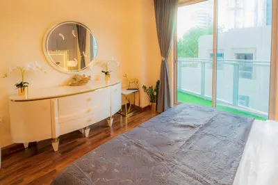 a bedroom with a mirror and a dresser and a window at FIRST CLASS 2BR with full BURJ KHALIFA and FOUNTAIN VIEW in Dubai
