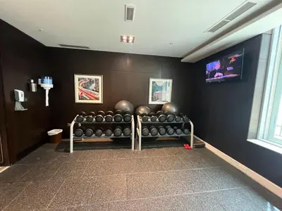 a gym with a bunch of dumbbells on a wall at FIRST CLASS 2BR with full BURJ KHALIFA and FOUNTAIN VIEW in Dubai