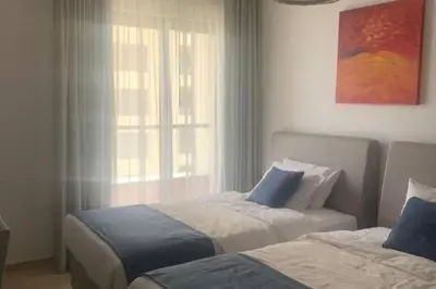 a bedroom with two beds and a window at Beautiful apartment with amazing sea views in Dubai