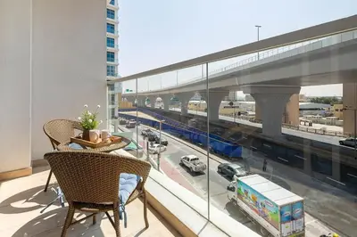 a balcony with a view of a city with a truck at Frank Porter - Studio One in Dubai