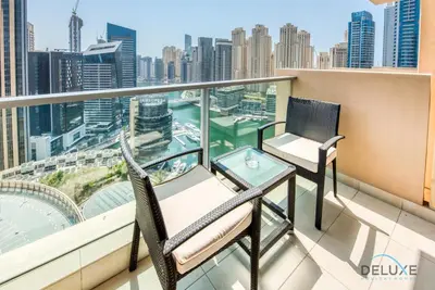 a balcony with two chairs and a table at Pristine 1BR at The Address Residences Dubai Marina by Deluxe Holiday Homes in Dubai
