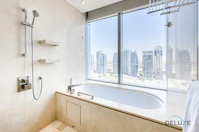 a bathroom with a tub and a large window at Pristine 1BR at The Address Residences Dubai Marina by Deluxe Holiday Homes in Dubai