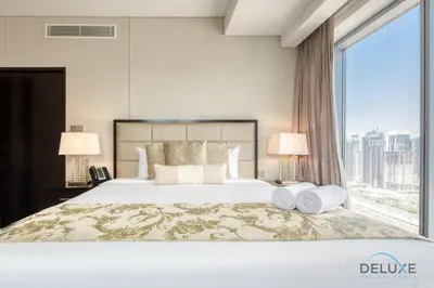 a bedroom with a large bed with a large window at Pristine 1BR at The Address Residences Dubai Marina by Deluxe Holiday Homes in Dubai