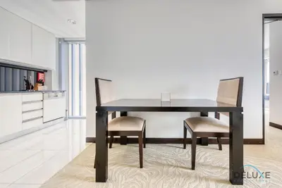 a black dining room table with two chairs in a kitchen at Pristine 1BR at The Address Residences Dubai Marina by Deluxe Holiday Homes in Dubai