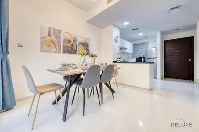 a kitchen and dining room with a table and chairs at Opulent 3BR Townhouse at DAMAC Hills 2 Dubailand by Deluxe Holiday Homes in Dubai