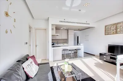 a living room with a couch and a table at 1 BD in West Avenue tower Dubai Marina in Dubai