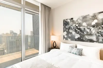 a bedroom with a bed and a large window at Luton Vacation Homes - Marina View & Luxury 1BR - Jumeirah Living Marina Gate Tower 3 - 54AB49AB36AB in Dubai