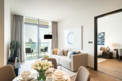 a living room with a couch and a table at Luton Vacation Homes - Marina View & Luxury 1BR - Jumeirah Living Marina Gate Tower 3 - 54AB49AB36AB in Dubai
