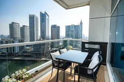 a balcony with a table and chairs and a view of the city at WSuites - Big Terrace with Beautiful Marina View in Dubai
