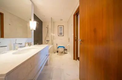 a bathroom with a sink and a toilet in it at New Arabian -Address Emaar Fashion Avenue in Dubai