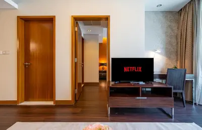a living room with a television on a table at New Arabian -Address Emaar Fashion Avenue in Dubai