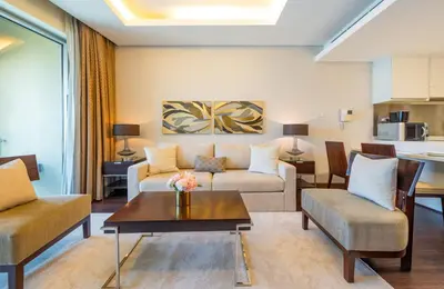 a living room with a couch and a table at New Arabian -Address Emaar Fashion Avenue in Dubai