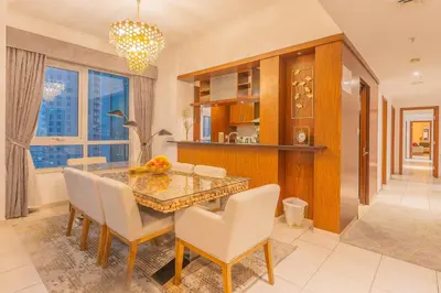 a dining room with a glass table and chairs at Spectacular Burj & Fountain View - Luxurious 3 Bedrooms & Maids room - The Residences in Dubai