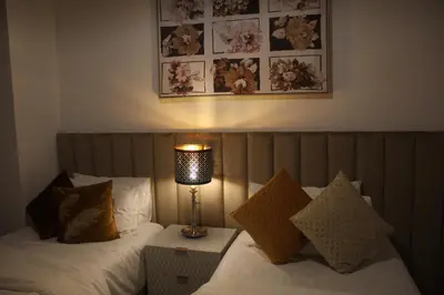 a bedroom with two beds with a lamp on it at Spectacular Burj & Fountain View - Luxurious 3 Bedrooms & Maids room - The Residences in Dubai