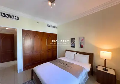 a bedroom with a large white bed in a room at Spectacular 2BR in Souk Al Bahar, Downtown with Burj & Dubai Mall view by Rich Stay in Dubai