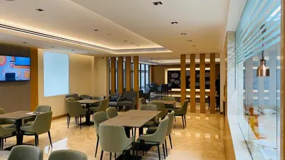 a restaurant with tables and chairs and a window at SITARA HOTEL APARTMENT in Dubai