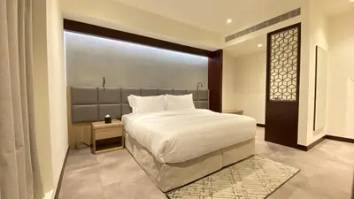a bedroom with a large bed and a window at SITARA HOTEL APARTMENT in Dubai