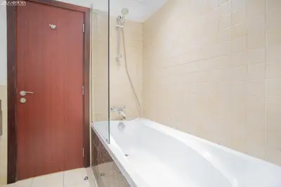 a bathroom with a bath tub and a shower at Gardenia Rimal Suites, Luxury Apartments in JBR with 2 min Walk to JBR beach in Dubai