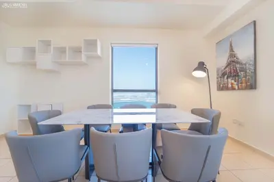 a dining room with a table and chairs at Gardenia Rimal Suites, Luxury Apartments in JBR with 2 min Walk to JBR beach in Dubai