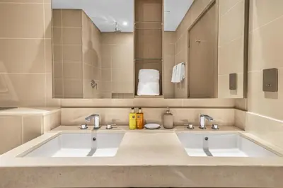 a bathroom with two sinks and a large mirror at EDEN'S Homes & Villas - 52-42 Emaar in Dubai