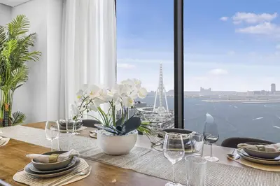 a dining table with a view of the eiffel tower at EDEN'S Homes & Villas - 52-42 Emaar in Dubai