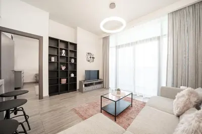 a living room with a couch and a tv at Tranquil Retreat with Canal View 1BR MBL Residence - 29AB12 in Dubai