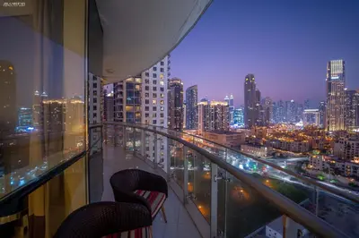 a view of a city at night from a balcony at Downtown Damac Distinction Full Burj View in Dubai