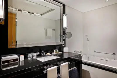a bathroom with a sink and a large mirror at Hilton Dubai Palm Jumeirah in Dubai