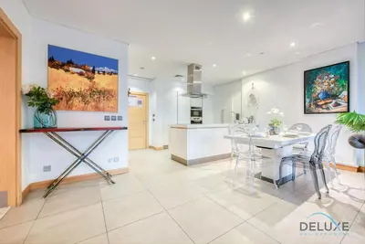 a kitchen and dining room with a table and chairs at Lively 1 BR at Al Nabat Shoreline 8 Palm Jumeirah by Deluxe Holiday Homes in Dubai