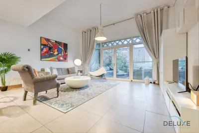 a living room with a couch and a chair at Lively 1 BR at Al Nabat Shoreline 8 Palm Jumeirah by Deluxe Holiday Homes in Dubai