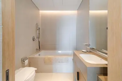 a bathroom with a tub and a toilet and a sink at EDEN'S Homes & Villas - ADDRESS BEACH Residences JBR in Dubai