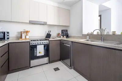 a kitchen with a stove and a sink at Frank Porter - Creekside18 in Dubai
