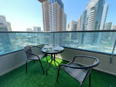 a balcony with two chairs and a table on a balcony at Private gorgeous Room with Marina view with Shared Kitchen in Shared Apartment in Dubai