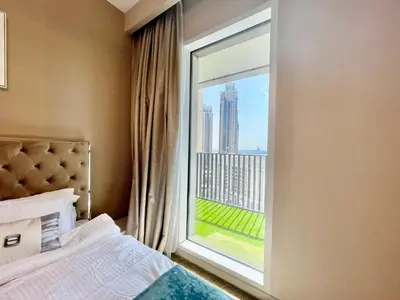 a bedroom with a window with a view of a city at Ultimate Luxury at Dubai Creek Horizon Waterfront in Dubai