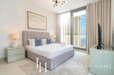 a bedroom with a large bed and a large window at LUX Contemporary Suite with Marina View 3 in Dubai