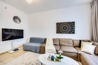 a living room with a couch and a table at Wonderful 2 Bedroom apartment in JBR in Dubai