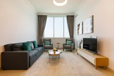 a living room with a couch and a tv at Manazel Al Safa in Dubai in Dubai
