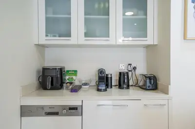 a kitchen counter with a coffee maker and appliances at Magic waves holiday in Dubai