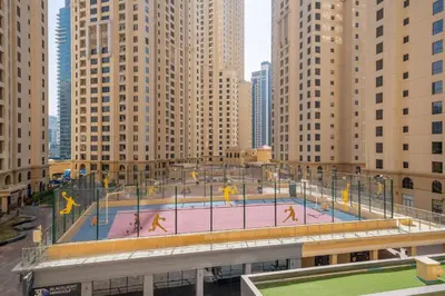 a basketball court in a city with tall buildings at Magic waves holiday in Dubai