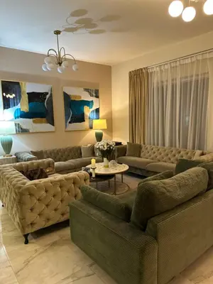 a living room with two couches and a table at Magic waves holiday in Dubai