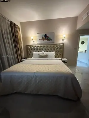 a bedroom with a large white bed in a room at Magic waves holiday in Dubai