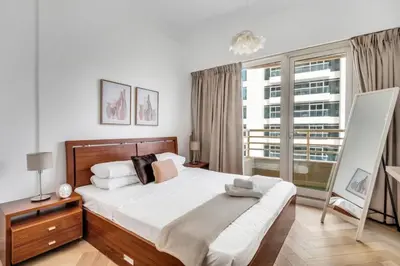 a bedroom with a bed and a large window at GuestReady - Marina Views | 1BR + Pool & Gym in Dubai