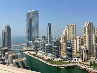 a city skyline with tall buildings and a river at GuestReady - Marina Views | 1BR + Pool & Gym in Dubai