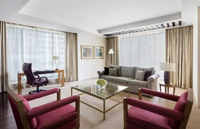 a living room with a couch and a table at The H Dubai in Dubai