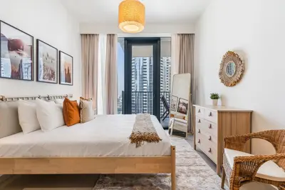 a bedroom with a bed and a desk and a chair at High-End Chic Apartment, Close to Burj Khalifa in Dubai