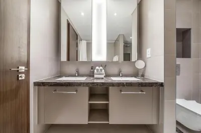 a bathroom with two sinks and a large mirror at High-End Chic Apartment, Close to Burj Khalifa in Dubai