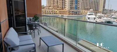 a balcony with a view of a harbor and boats at Palm Jumeirah 1BR luxurious & gorgeous view in Dubai